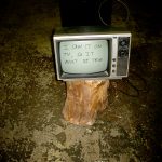 an old television on top of an up ended log with the words "I saw it on tv, so it must be true" written onto the screen