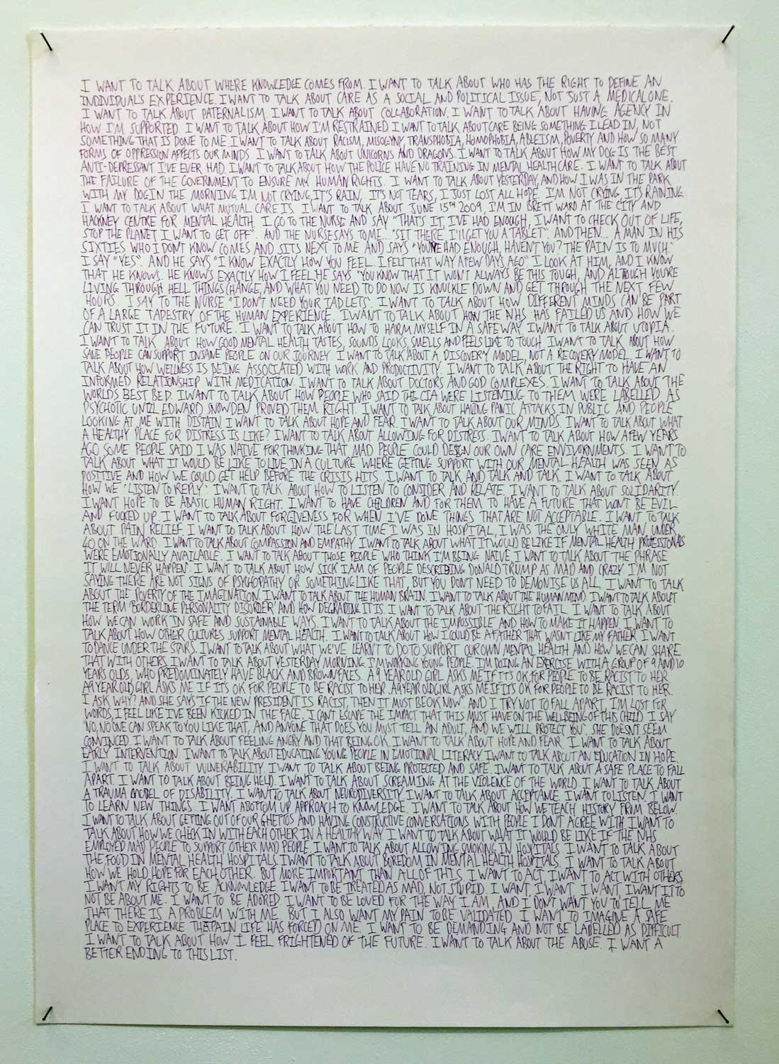 a piece of writing, hand written in capitals, pinned to the wall