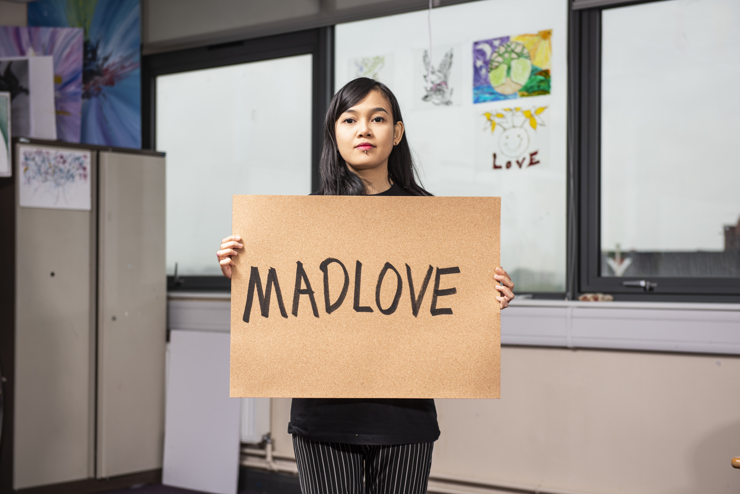 Madlove poster held by Hana Madness